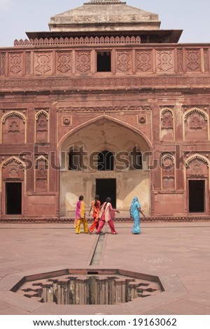 Group of Indian ladies in colorful clothing in front of an islamic style palace inside the Red Fort at Agra, Uttar Pradesh, India