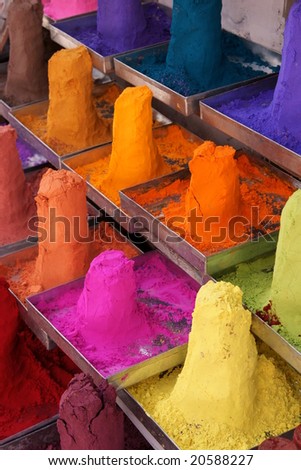 Piles of colored powder displayed on a market stall in the holy town of Pushkar, India