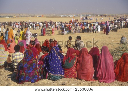 JAISALMER, INDIA - FEBRUARY 1, 2007: Indian women in colorful saris watching events at the desert festival on February 1, 2007 in Jaisalmer, Rajasthan, India.