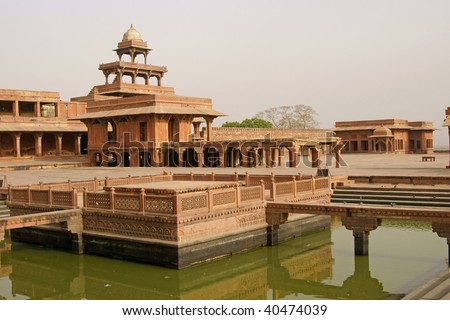 Deserted Mughal city of Fatehpur Sikri. Red sandstone buildings set around formal gardens and ornamental pool. Uttar Pradesh, India. 16th Century AD.