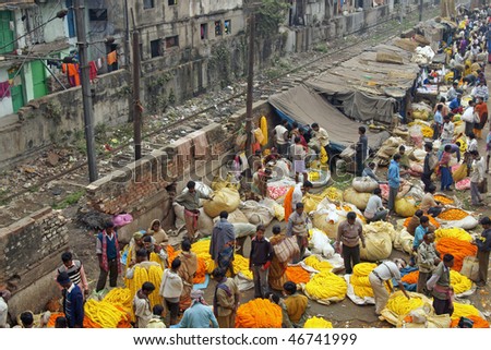 KOKATA, INDIA - DECEMBER 18: People buying and selling flowers and garlands at the flower market next to a railway track on December 18, 2008 in Kolkata (Calcutta), West Bengal, India