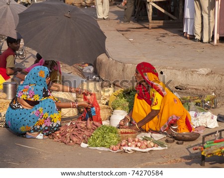 JAIPUR, INDIA - NOVEMBER 12: An unidentified woman sells vegetables by the road on November 12, 2007 in Jaipur, Rajasthan, India. In India poor women often sell vegetables to earn a small cash income.