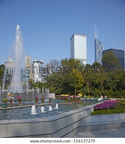 HONG KONG, CHINA - FEBRUARY 1: Colorful flowers and fountains in Hong Kong Botanical Gardens surrounded by tall office buildings on February 1, 2012 in Hong Kong, China.