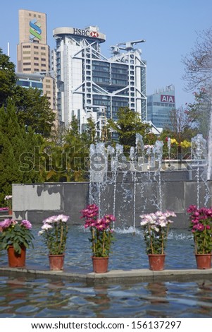 HONG KONG, CHINA - FEBRUARY 1: Colorful flowers and fountains in Hong Kong Botanical Gardens surrounded by tall office buildings on February 1, 2012 in Hong Kong, China.