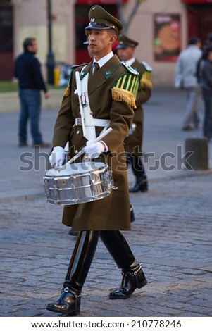 SANTIAGO, CHILE - AUGUST 8, 2014: Member of the Carabineros Band marching and playing the drum as part of the changing of the guard ceremony at La Moneda in Santiago, Chile