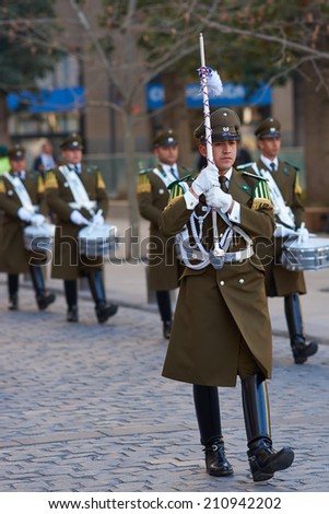 SANTIAGO, CHILE - AUGUST 8, 2014: Leader of the Carabineros Band marching as part of the changing of the guard ceremony at La Moneda in Santiago, Chile