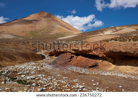 Dry riverbed running through the colourful desert landscape in Lauca National Park set in the altiplano of northern Chile