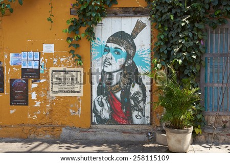 CARTAGENA, COLOMBIA - JANUARY 26, 2015: Colourful mural decorating a wooden door in the Getsemini area of the historic city of Cartagena in Colombia