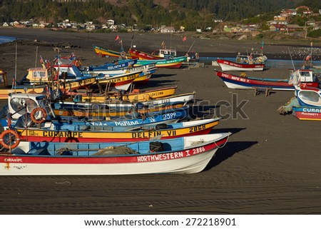 CURANIPE, CHILE - APRIL 20, 2015: Colourful fishing boats on the beach in the small fishing village of Curanipe in the Maule Region of Chile.