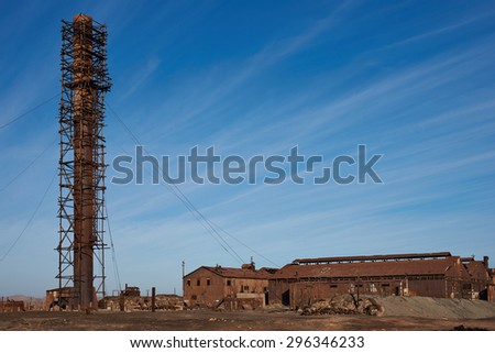 Derelict and rusting industrial buildings at the historic Humberstone Saltpeter Works in the Atacama Desert near Iquique in Chile. The site is now an open air museum and a Unesco World Heritage SIte.