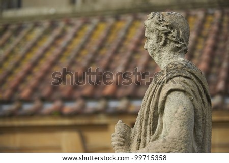 Old weathered stone statue above the ancient Roman Baths in Bath, Somerset, England.