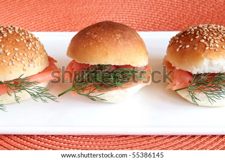 Smoked salmon party buns on a white rectangular plate