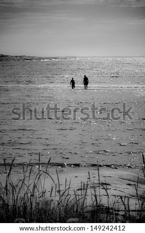 Silhouette  of two persons wading in the sea, Hvaler - Norway