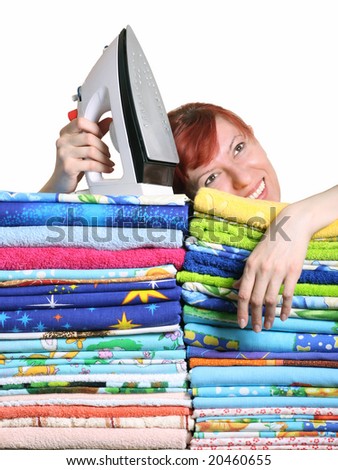Household iron and greater pile of bed-clothes on a white background.