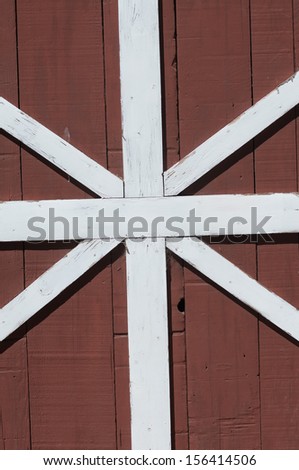 Old red barn door with white trim