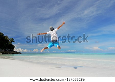 A Man Jumping on a Tropical White Sand Beach of Tachai Island, Similan Islands National Park, Phang Nga, Thailand