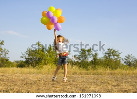Funny little girl with balloons, bouncing outdoor