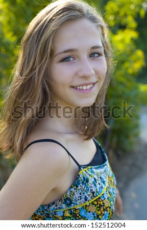 Portrait of the young sixteen-year-old smiling girl