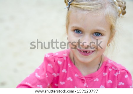 portrait of emotional beautiful five-year-old girl outdoors