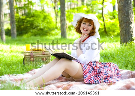 Romantic young pin-up girl resting in the forest