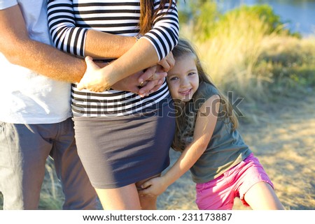 Five year old girl with her parents outdoors