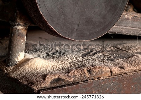 Wooden sawdust and electric grinding machine. Horizontal photo.