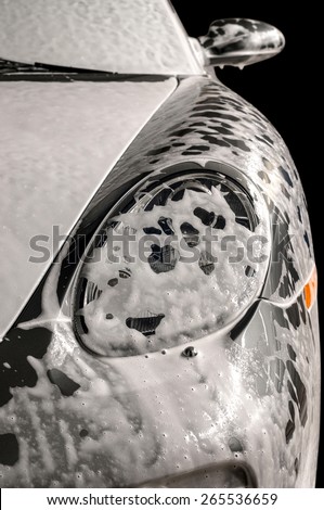 Car wash with soap. Modern auto covered by foam.