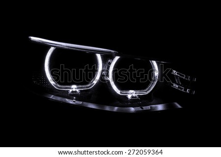 LED headlights of car on black background. Exterior detail.