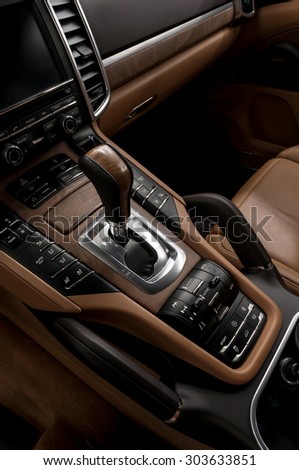 Luxury automatic car transmission control buttons and gear lever. Interior detail.