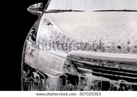 Car wash with soap. Modern auto covered by foam.