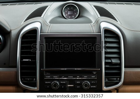 Luxury car dashboard. Multimedia screen. Interior detail.
