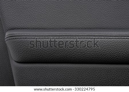 Leather  background. Auto door armrest. Modern business car interior detail.