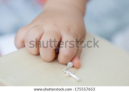 Baby hand holding jewel