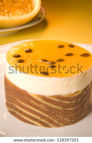 Passion fruit cake and sliced passion fruit on background