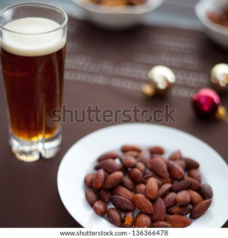 Roasted Almonds in a Bowl beside Glass of Beer