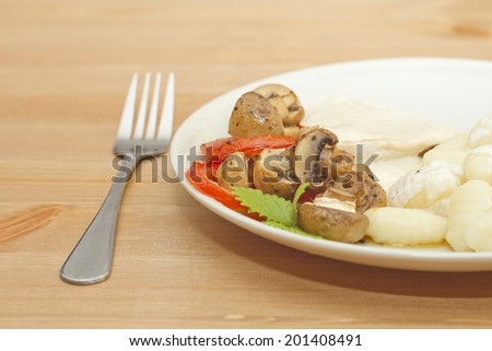 fresh chicken meat with gnocchi, muschrooms, cream sauce