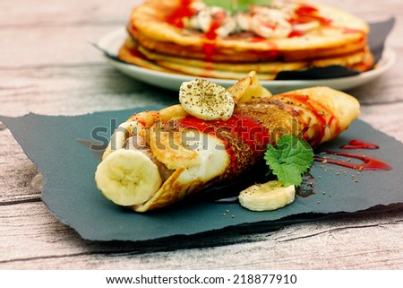 pancakes with chocolate ice cream and strawberry sauce.