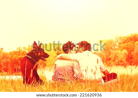 in love woman with man and dogs kiss