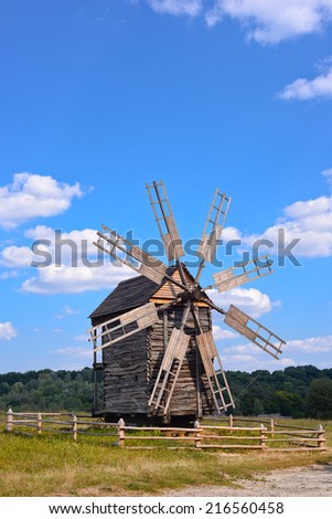 Old wooden windmill on background of blue sky, Kyiv region, Ukraine/Wooden windmill/Old wooden windmill