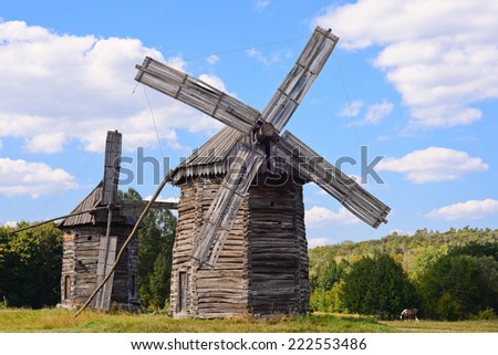 Old wooden windmills on background of blue sky, Kyiv region, Ukraine/Wooden windmills/Old wooden windmills