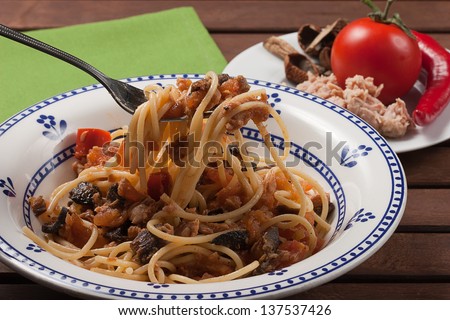 spaghetti carrettiera, typical dish of traditional Roman and Italian cuisine made from spaghetti pasta, dried mushrooms, tuna, onion, olive oil