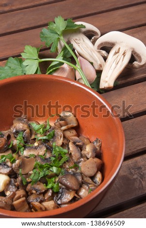 mushrooms cooked in a pan with garlic parsley olive oil