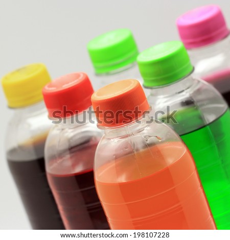 colorful of soft drink bottles on isolated background