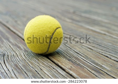 yellow tennis ball  on wooden background