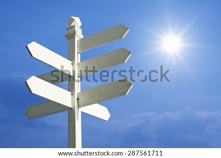direction sign with blank spaces for text on beautiful sunlight  background