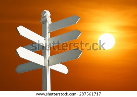 direction sign with blank spaces for text on beautiful sunset background
