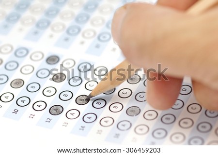 answer sheet test score with pencil and human hand
