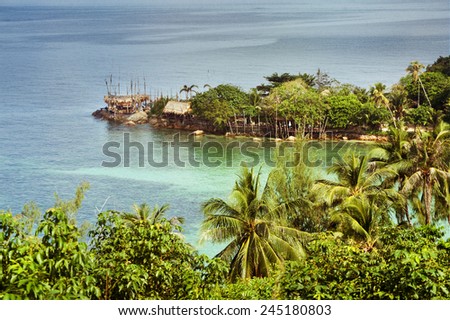 Beautiful landscape with sea bay, clear water, house of straw and palm trees