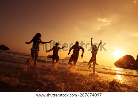 Group of young friends having fun on the beach. Phranang beach, Krabi province, Thailand
