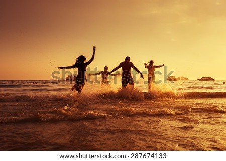 Group of young friends having fun on the beach